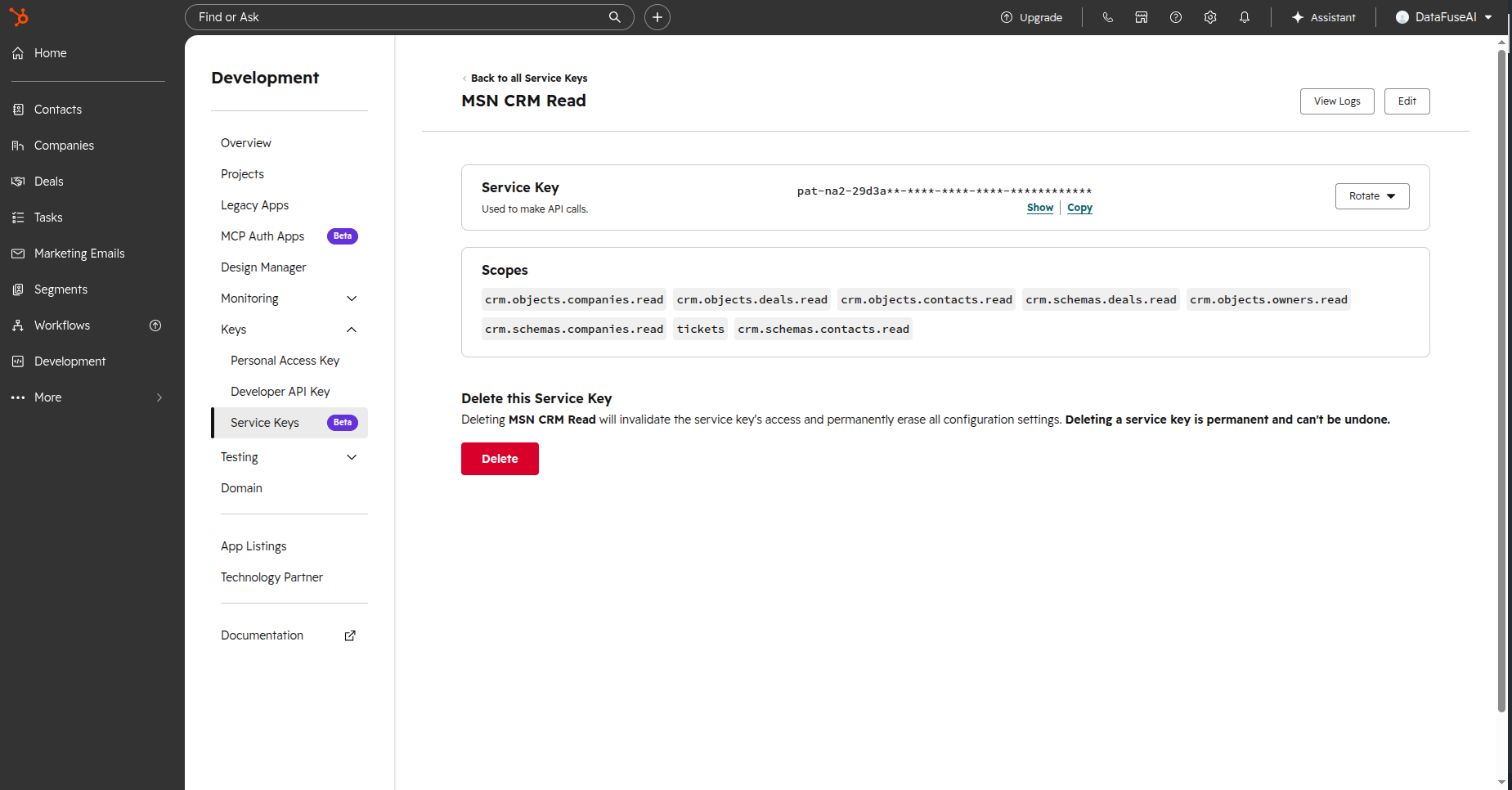 HubSpot Service Keys screen with the read-only CRM scopes ticked and the key value masked